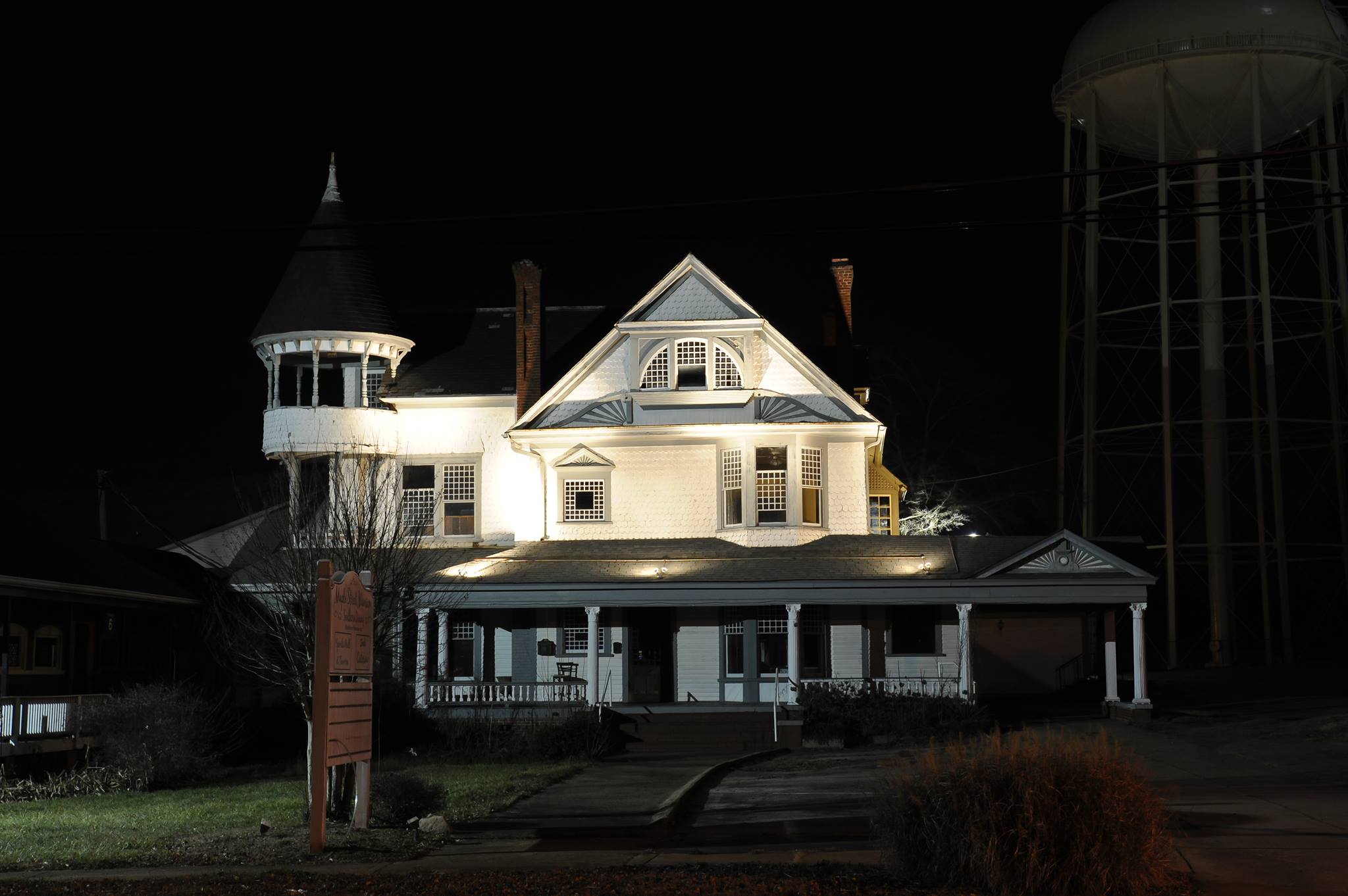 Mansion at night with water tower
